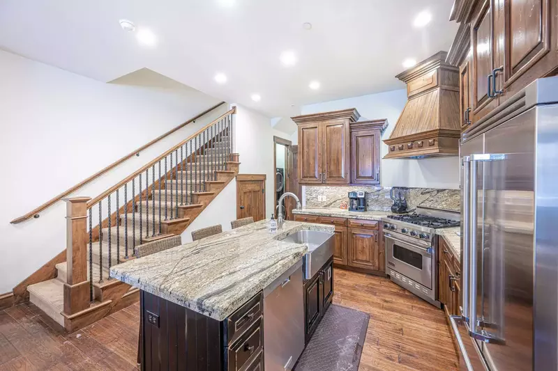 This high end home has a stainless steel farmhouse sink and the bedrooms up both upstairs to provide endless privacy
