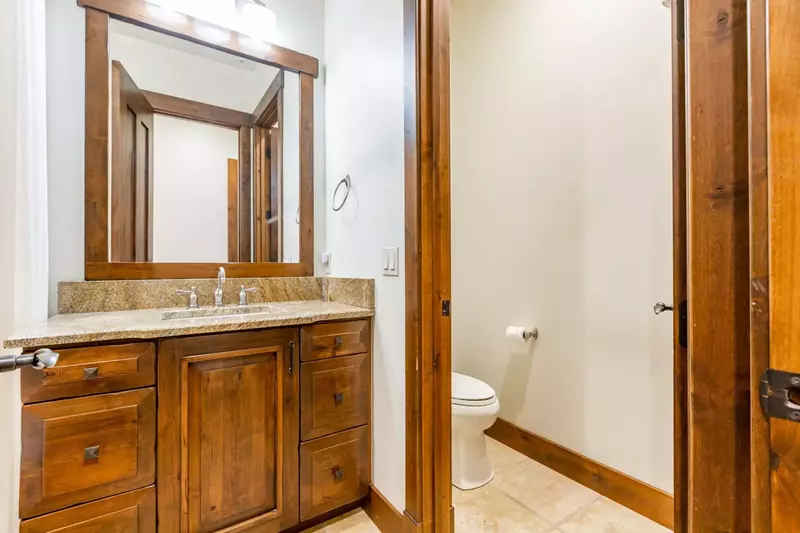The en-suite bathroom is equipped with a dual-vanity sink.