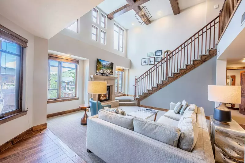 High ceiling with fireplace nook and a Flat Screen TV