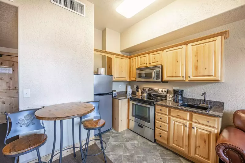 Newly updated, fully equipped kitchen with stainless steel appliances, knotty alder cupboards, and granite countertops and full size stainless applian