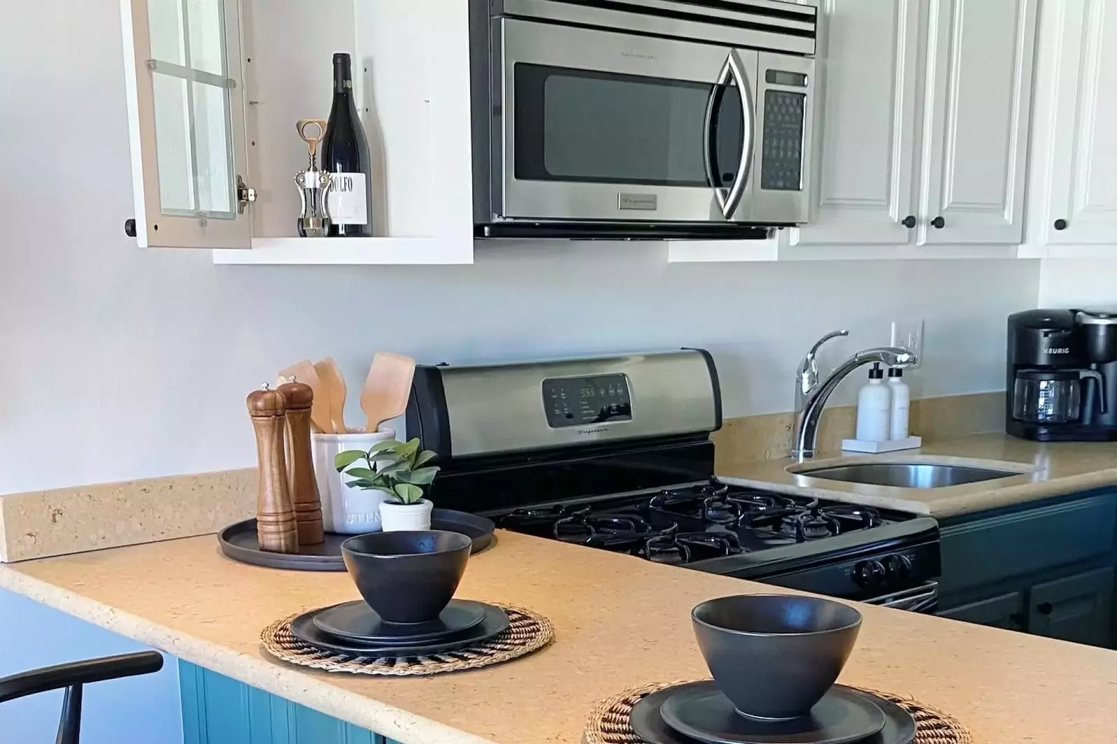 Newly updated kitchen that is stocked with all basic cooking necessities including a microwave, stove and oven, fridge and freezer, dishwasher, pod-st