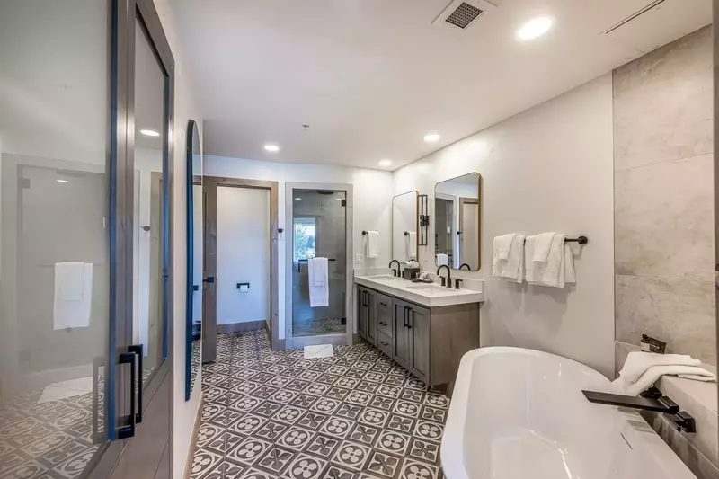 Relax in the en suite primary bathroom that features dual vanities and a walk in shower