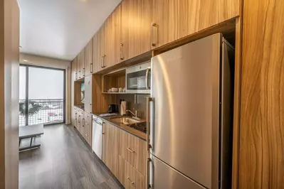 A full kitchenette with all new appliances includes a full sized dishwasher, microwave, fridge/freezer, and a 2 burner stove