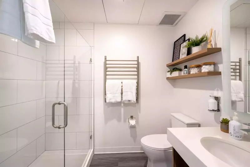 The private bathroom is well appointed with quartz counters, heated towel rack and an over sized walk in shower.