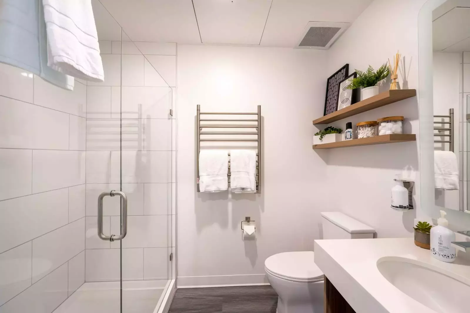 The private bathroom is well appointed with quartz counters, heated towel rack and an over sized walk in shower.