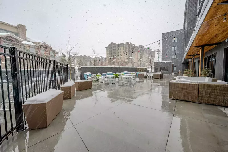 Take in the mountain views while relaxing in the modern outdoor furniture on the patio of the YotelPAD resort who offers ski valet and storage