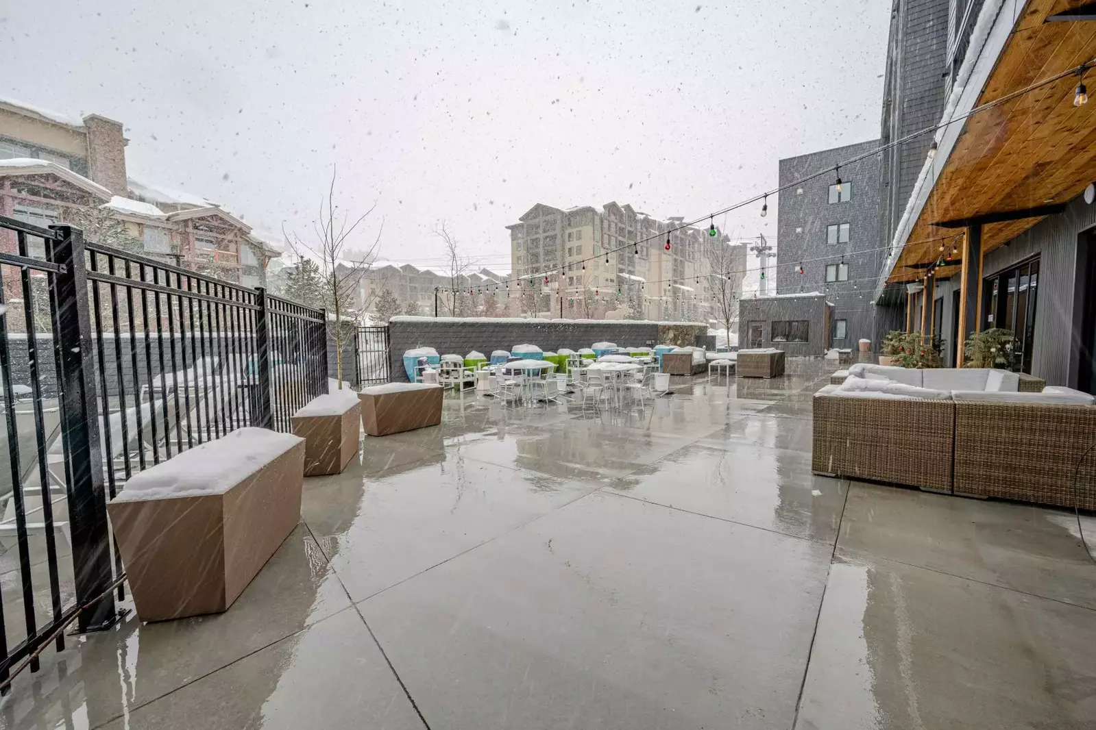 Take in the mountain views while relaxing in the modern outdoor furniture on the patio of the YotelPAD resort who offers ski valet and storage