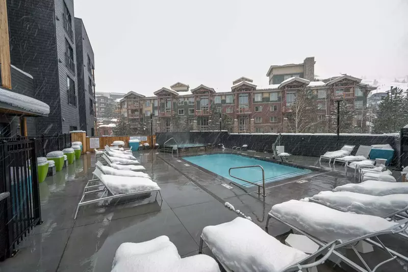 Outdoor Heated pool and hot tub are just steps away from the home and feature views of the mountains