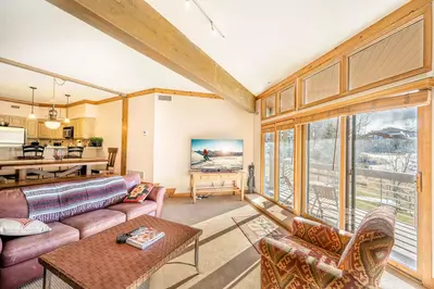 Cozy family room with great natural lighting and mountain views and access to deck