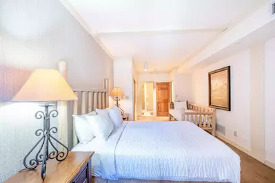 Clean and pretty guest bedroom with queen bed and twin day bed