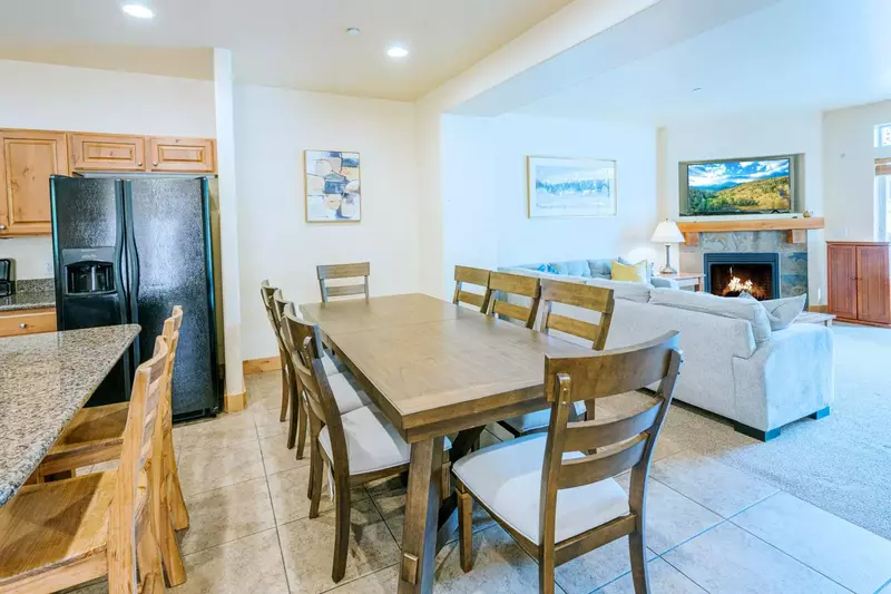 Adjacent to the living room is a dining room with hardwood dining table with seating for up to eight guests. Additional guests could sit at the breakf