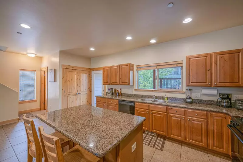 Clean, spacious and fully stocked kitchen with granite counter tops