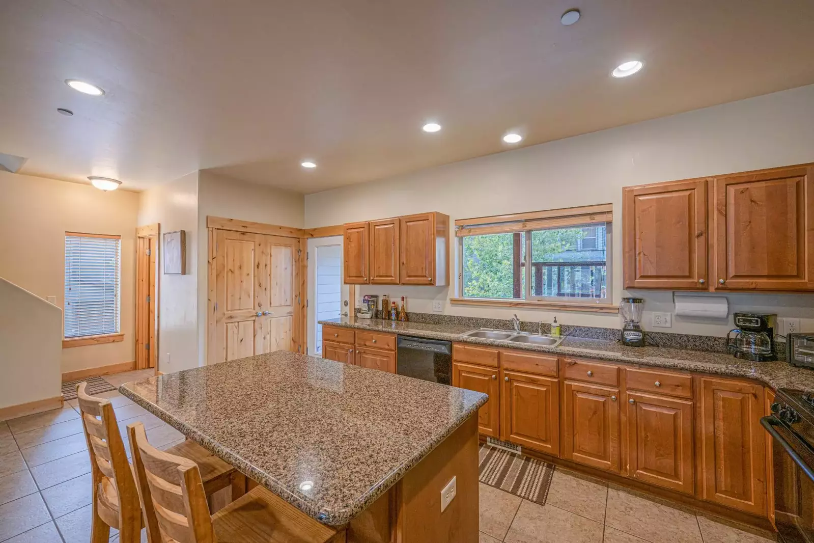 Clean, spacious and fully stocked kitchen with granite counter tops