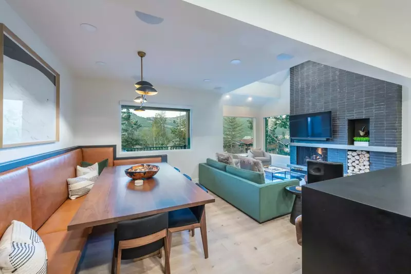 Living Room has Large gas fireplace with stunning brick wall, 65" wall-mounted HD Smart TV and lots of light through new and enlarged windows