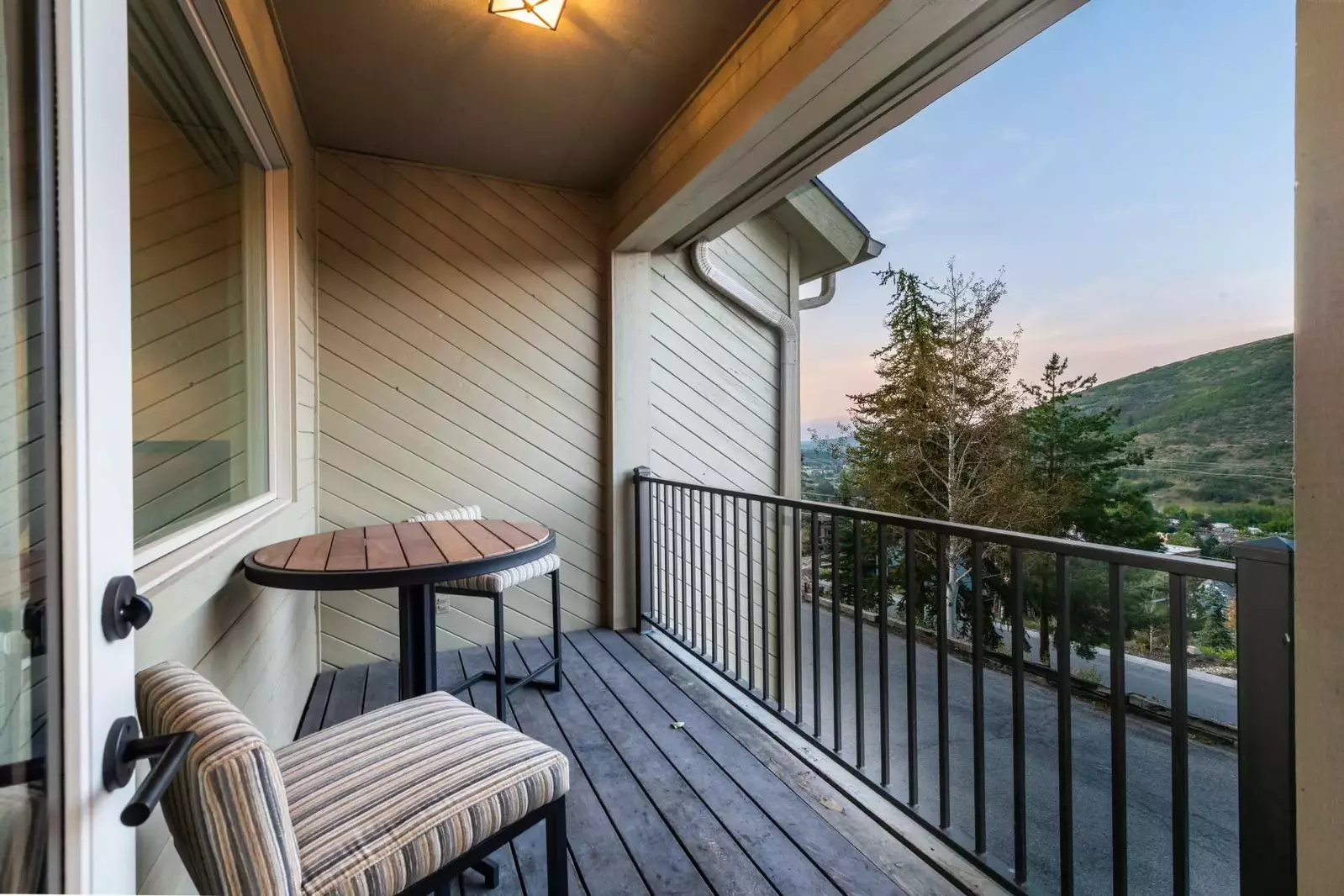 This balcony is perfect for enjoying your morning cup of coffee. It is located in the front of the house and offers comfortable seating, patio dining