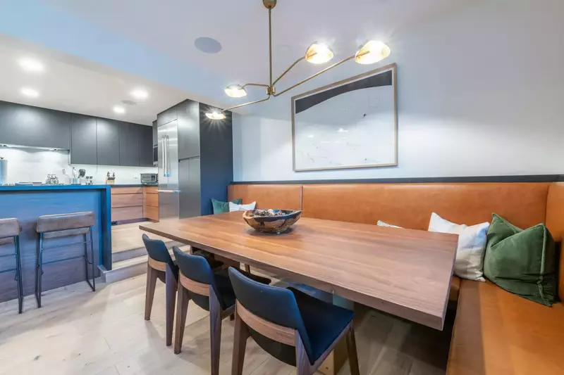 Dining area with custom dining table and banquet that adjoins the living room and kitchen with seating for 8,