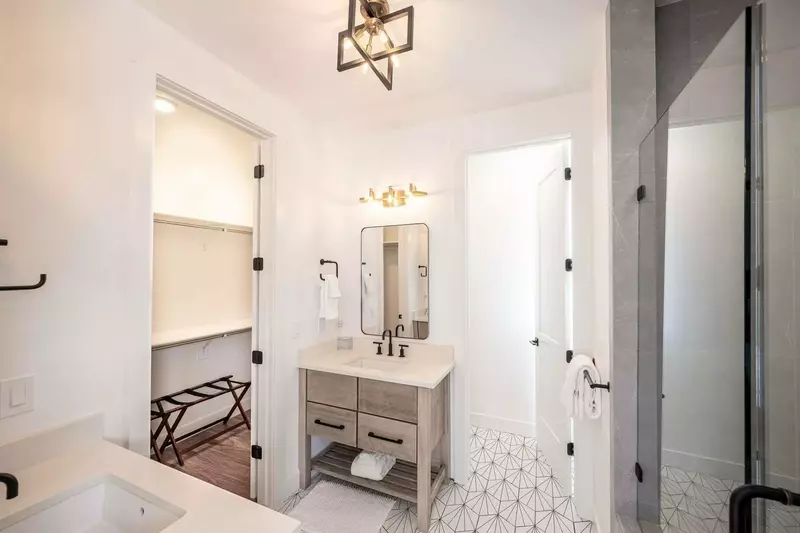 Through the sliding barn door is the exquisite en suite bathroom