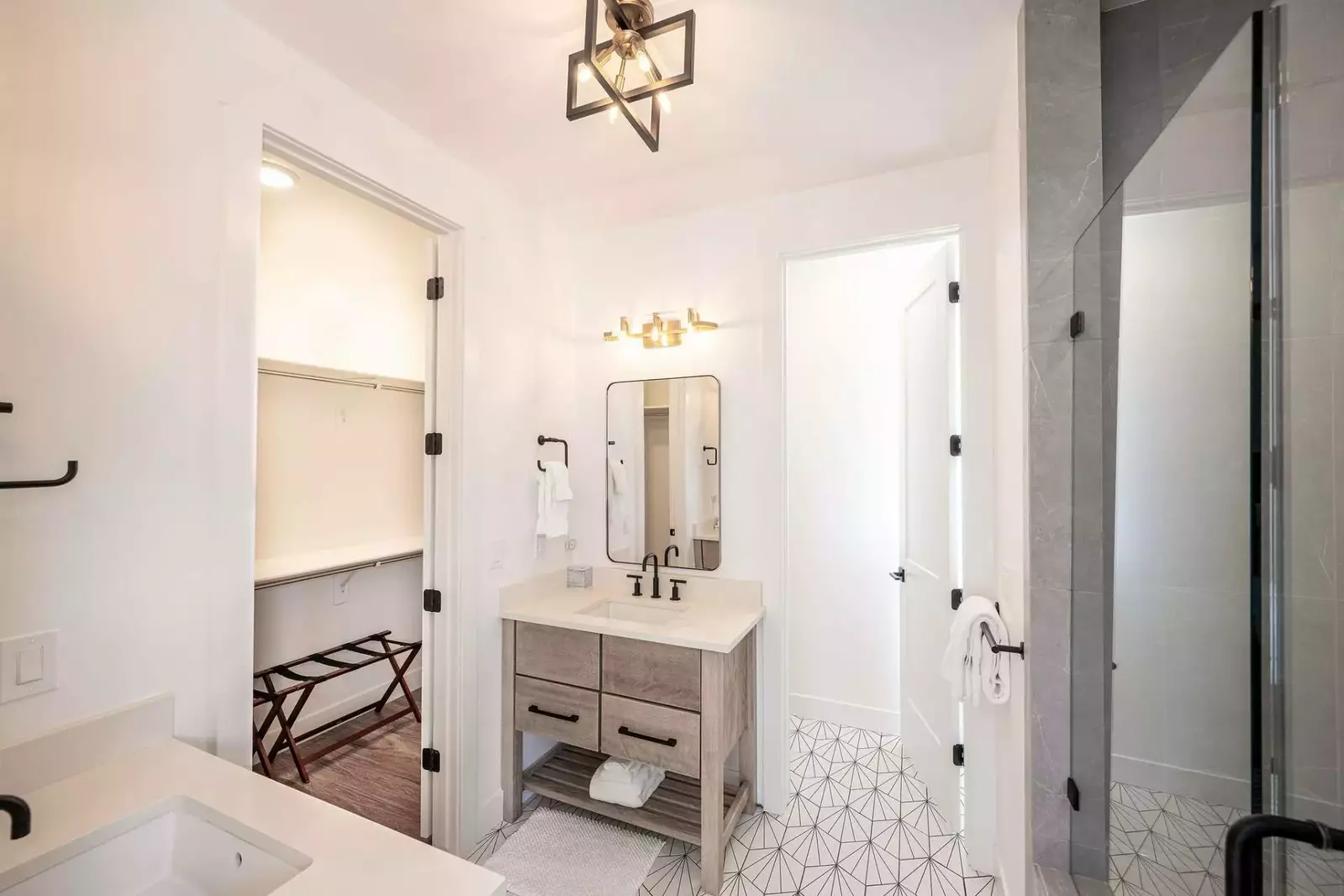 Through the sliding barn door is the exquisite en suite bathroom