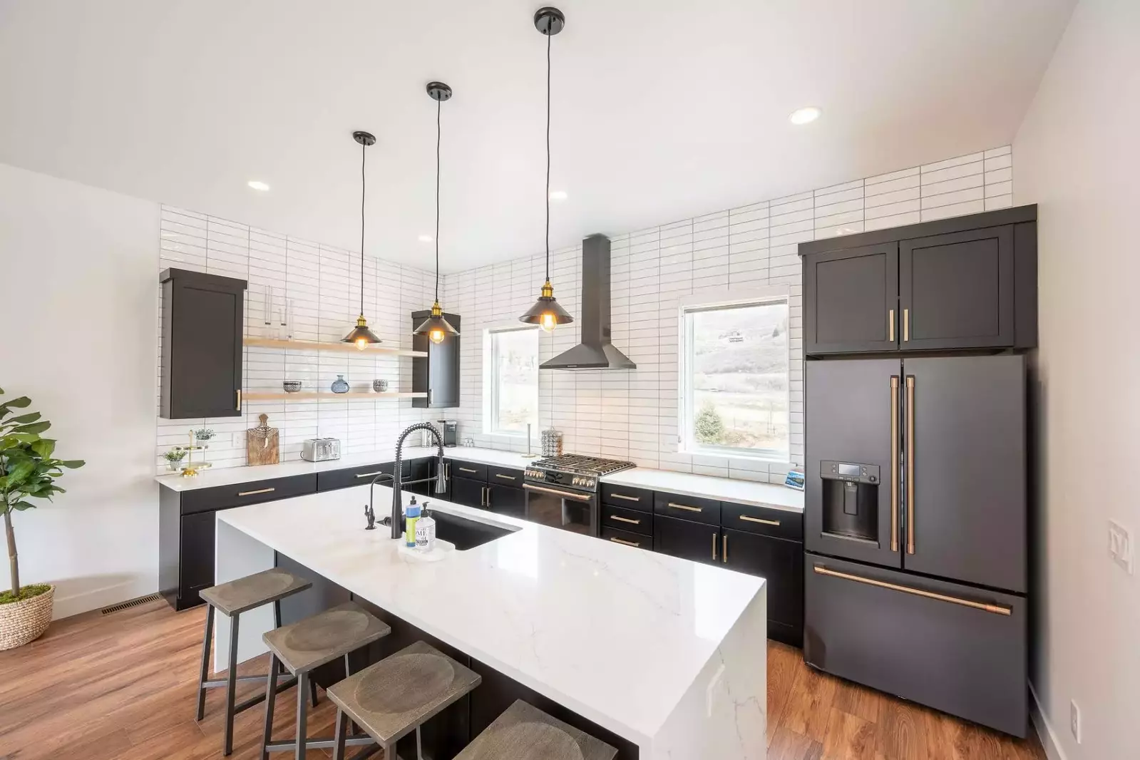 White quartz waterfall edge breakfast bar with additional seating for (4)