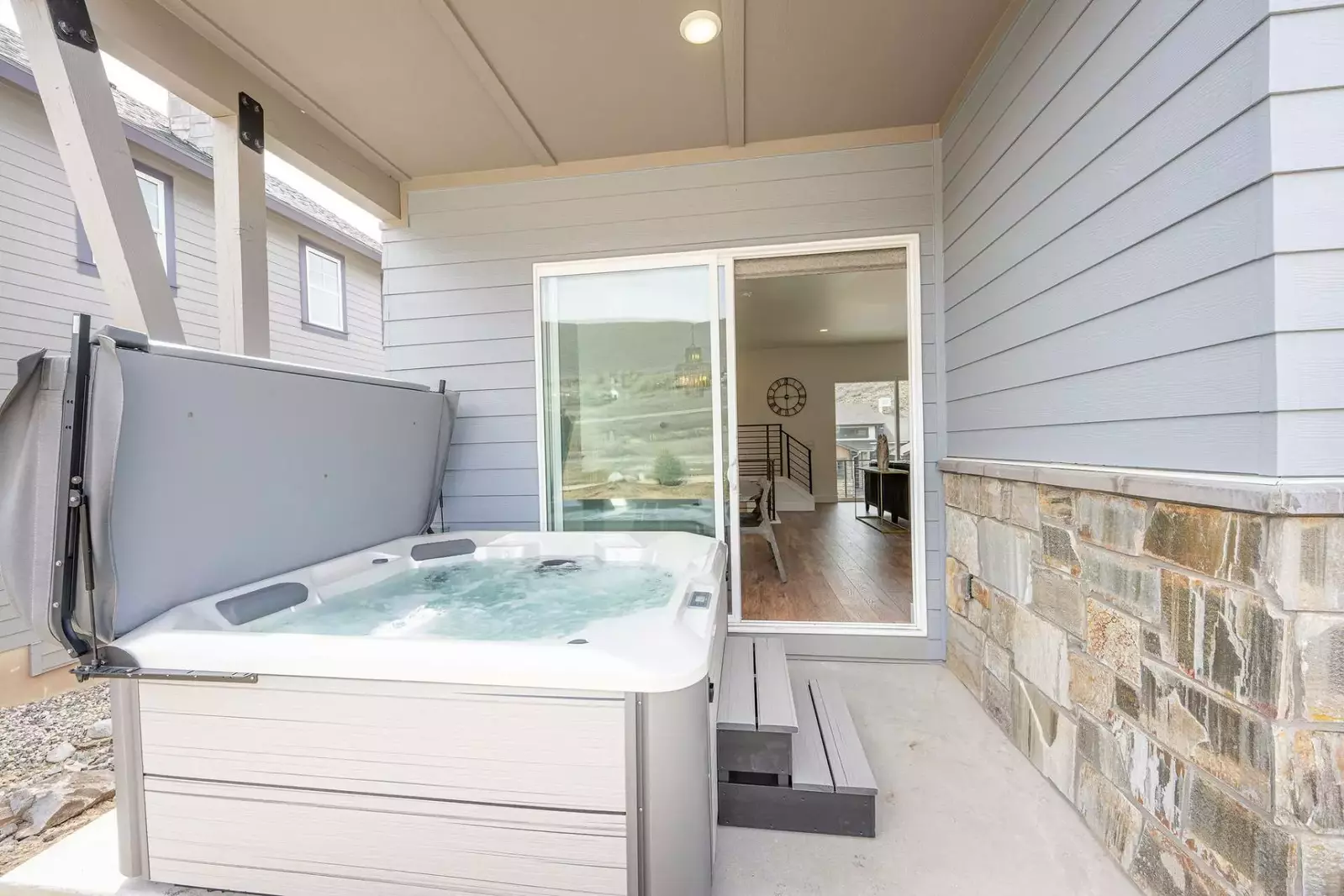 Private hot tub on the outdoor covered patio, the perfect way to relax at home.