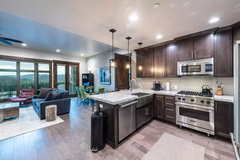 Fully Stocked Kitchen with Full Size High End Stainless Steel Appliances, Breakfast Bar and Open Floor Plan