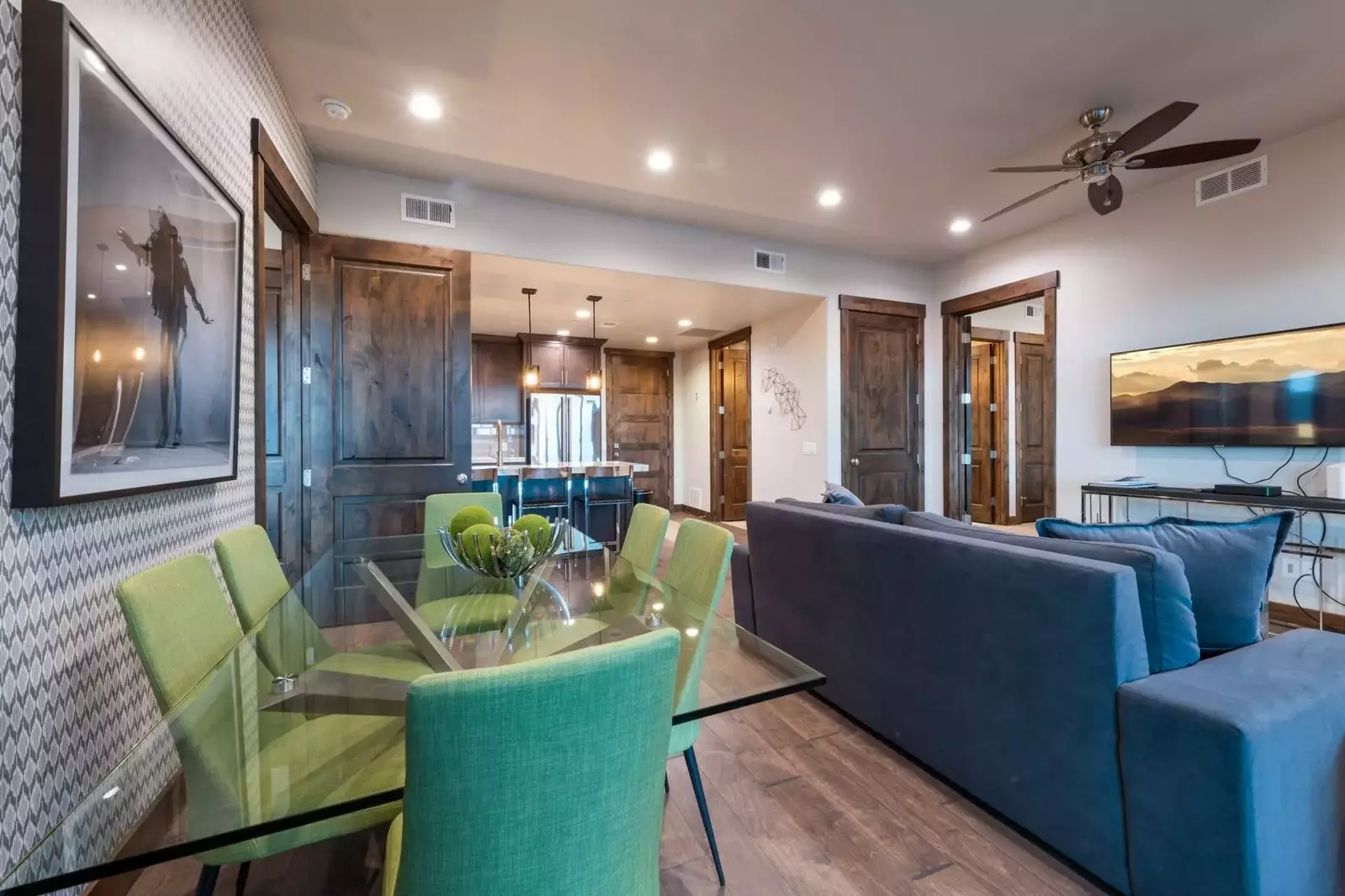 The dining room has a custom glass dining table and comfortable upholstered chairs, beautiful lighting, and outstanding views!