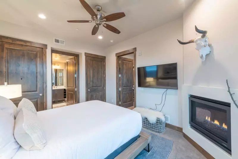 Indulgent primary suite with plush king bed and high end mattress. The bed is outfitted with high quality triple sheeting which is professionally laun