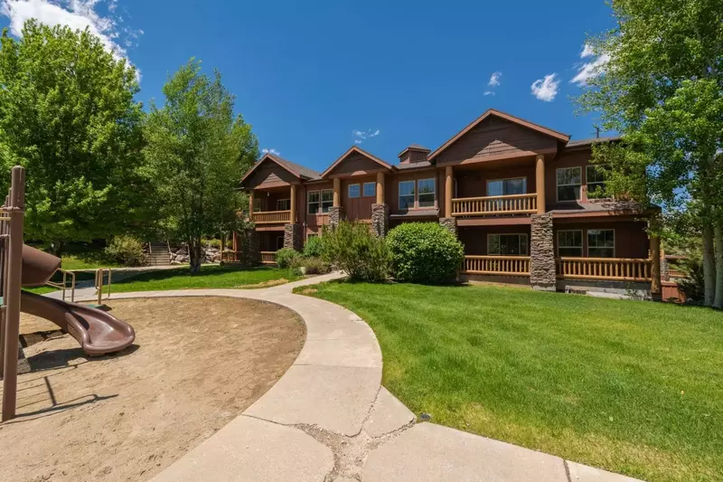 The backyard of the building features a playground that is perfect for kids and large grass areas to relax on.