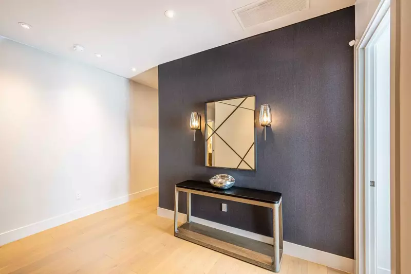 The spacious foyer features wood flooring, a keyless entry and welcomes guests with elegant finishes and designer furnishings.