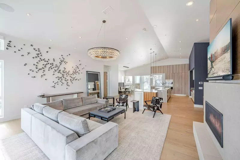 Luxurious furnishings adorn this open concept living room and dining room. Walk right out the back door to the mountain.