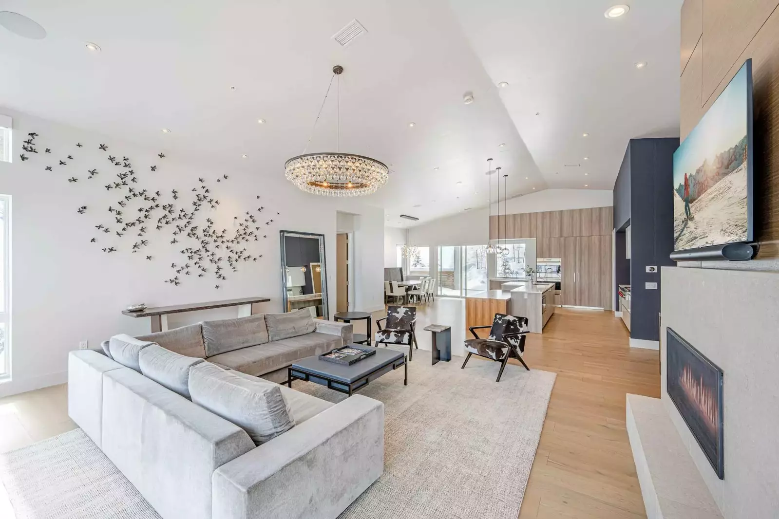 Luxurious furnishings adorn this open concept living room and dining room. Walk right out the back door to the mountain.