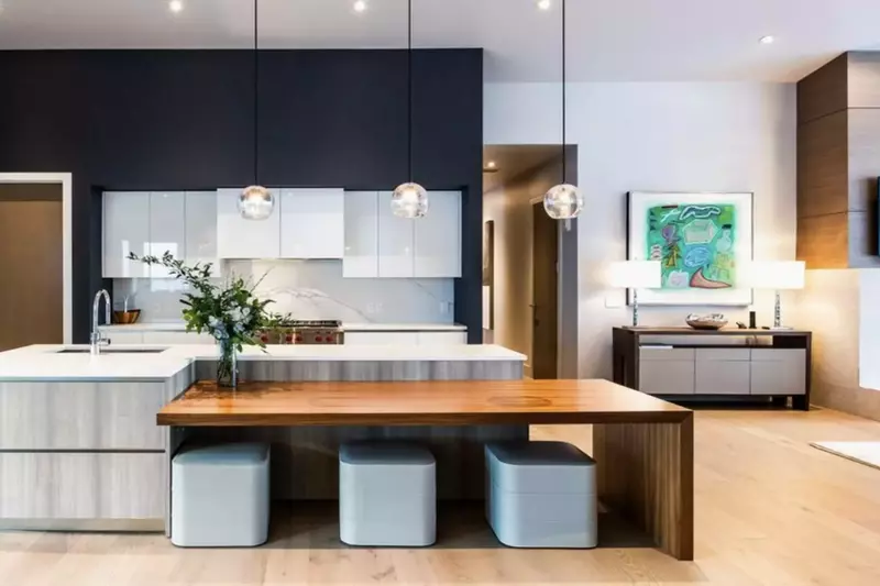 Gourmet kitchen featuring hardwood floors, white quartz countertops, Wolf Range & Oven, Breakfast Bar