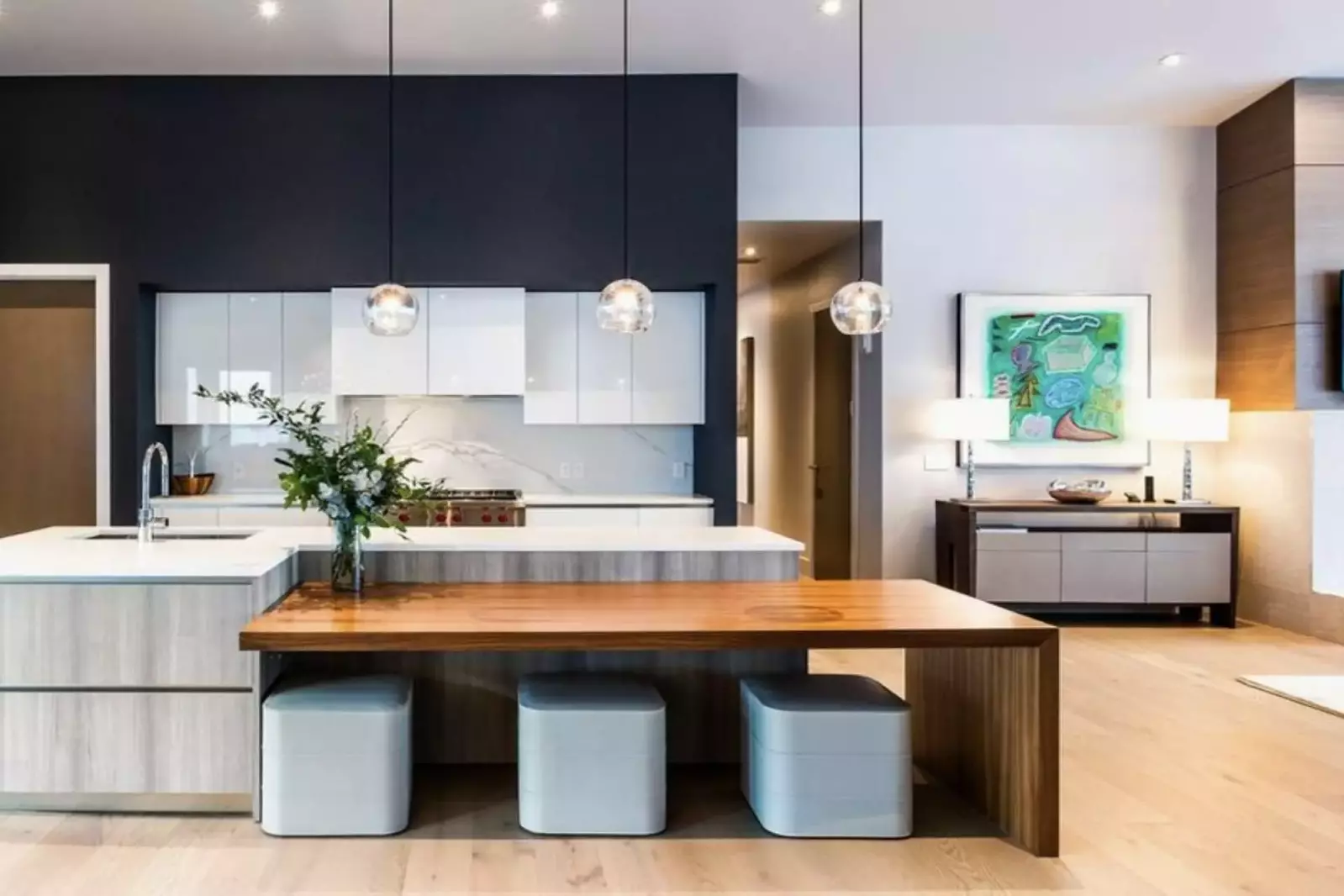 Gourmet kitchen featuring hardwood floors, white quartz countertops, Wolf Range & Oven, Breakfast Bar