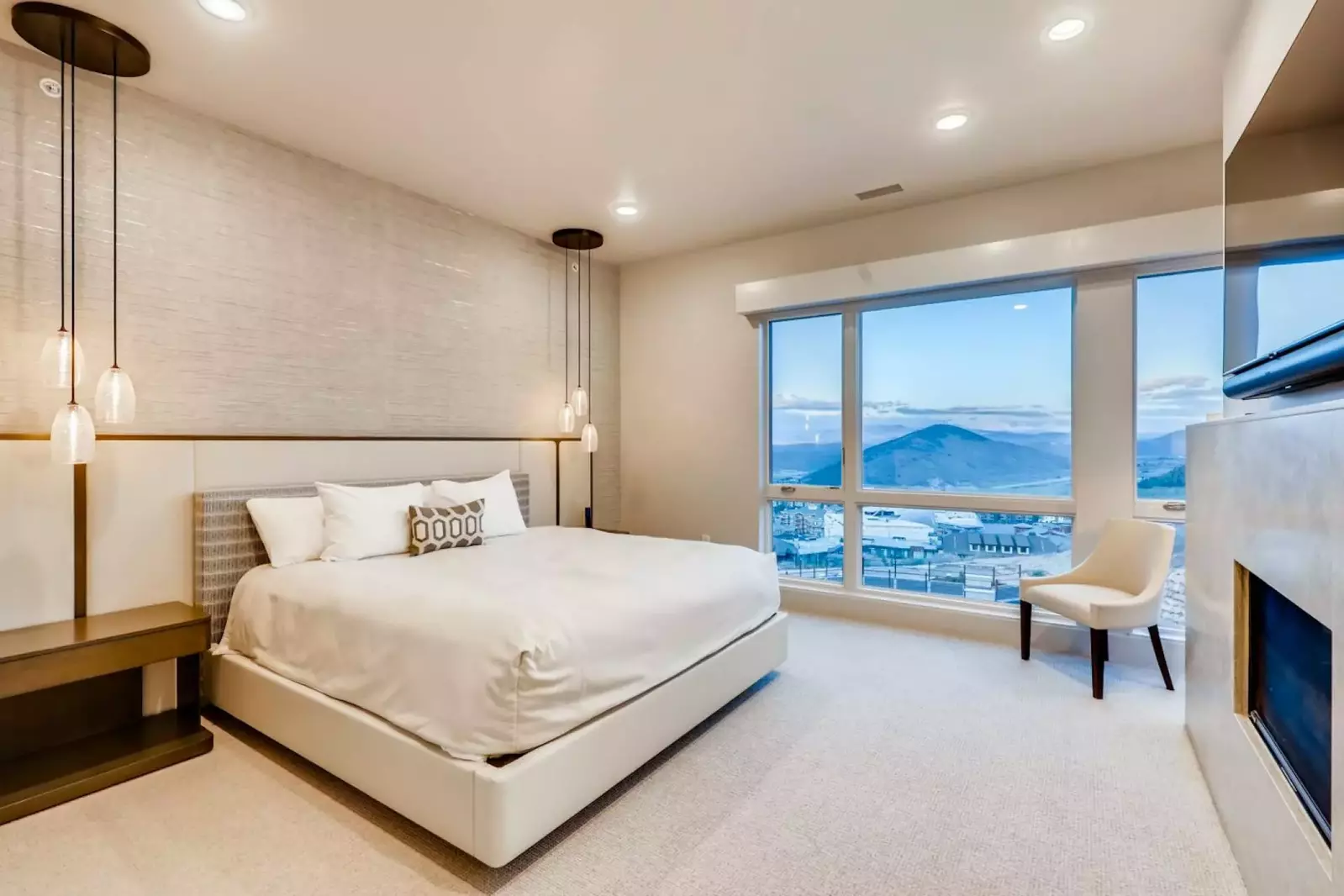 The Elegant and Modern Primary Retreat has a High End King Bed, Gas Fireplace, Smart HDTV and Large windows that perfectly frame one of a kind views.