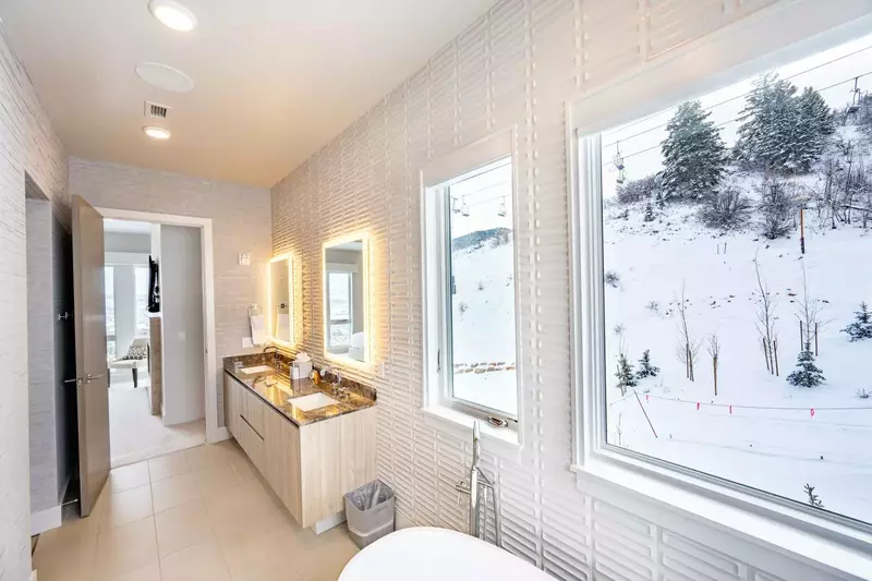 The Primary suite bathroom resembles a high end spa; with a freestanding oversized soaking tub and walk in glass shower guests will feel luxuriously p