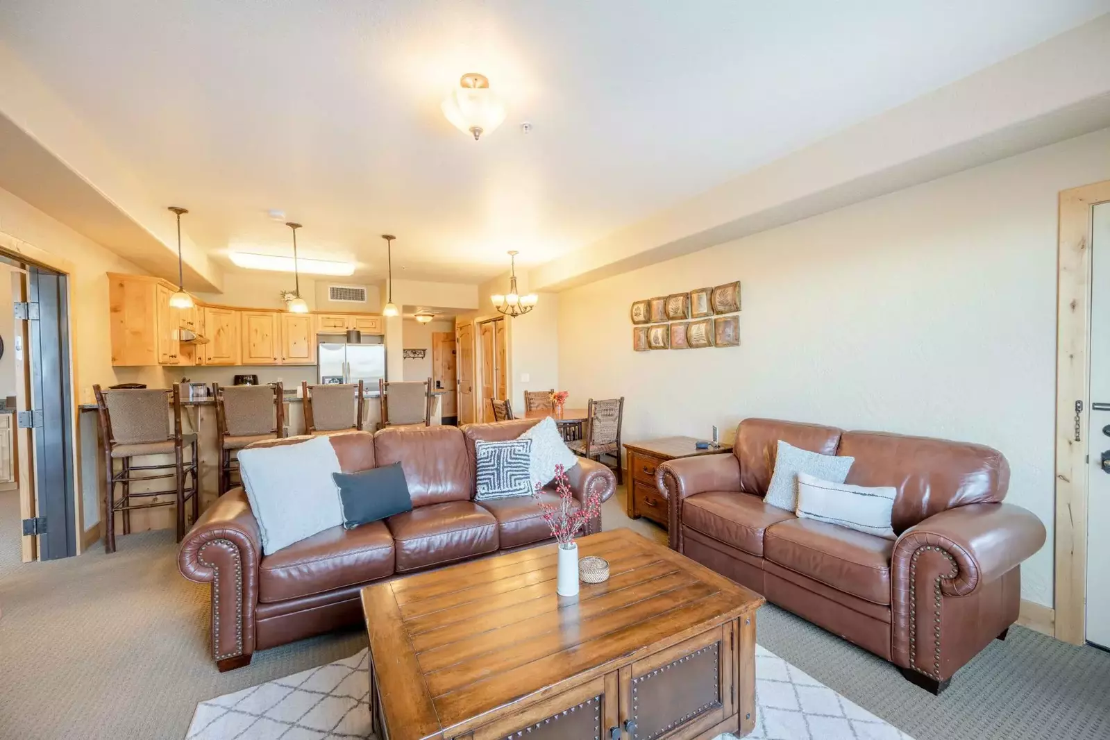 The warm and inviting family room has a mounted HDTV, gas fireplace, leather sofa and loveseat .There is plenty of room for everyone to relax by the f