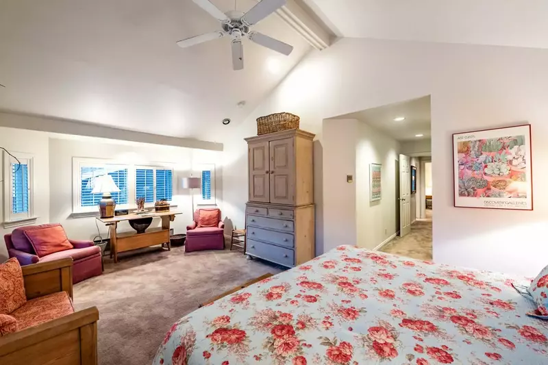 Master bedroom with king bed, lounge area and en suite bathroom.