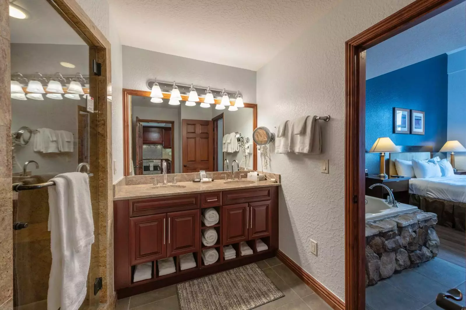 The master bath has a his and hers vanity, large tile countertop, large soaker tub with jets, walk-in shower and toilet.