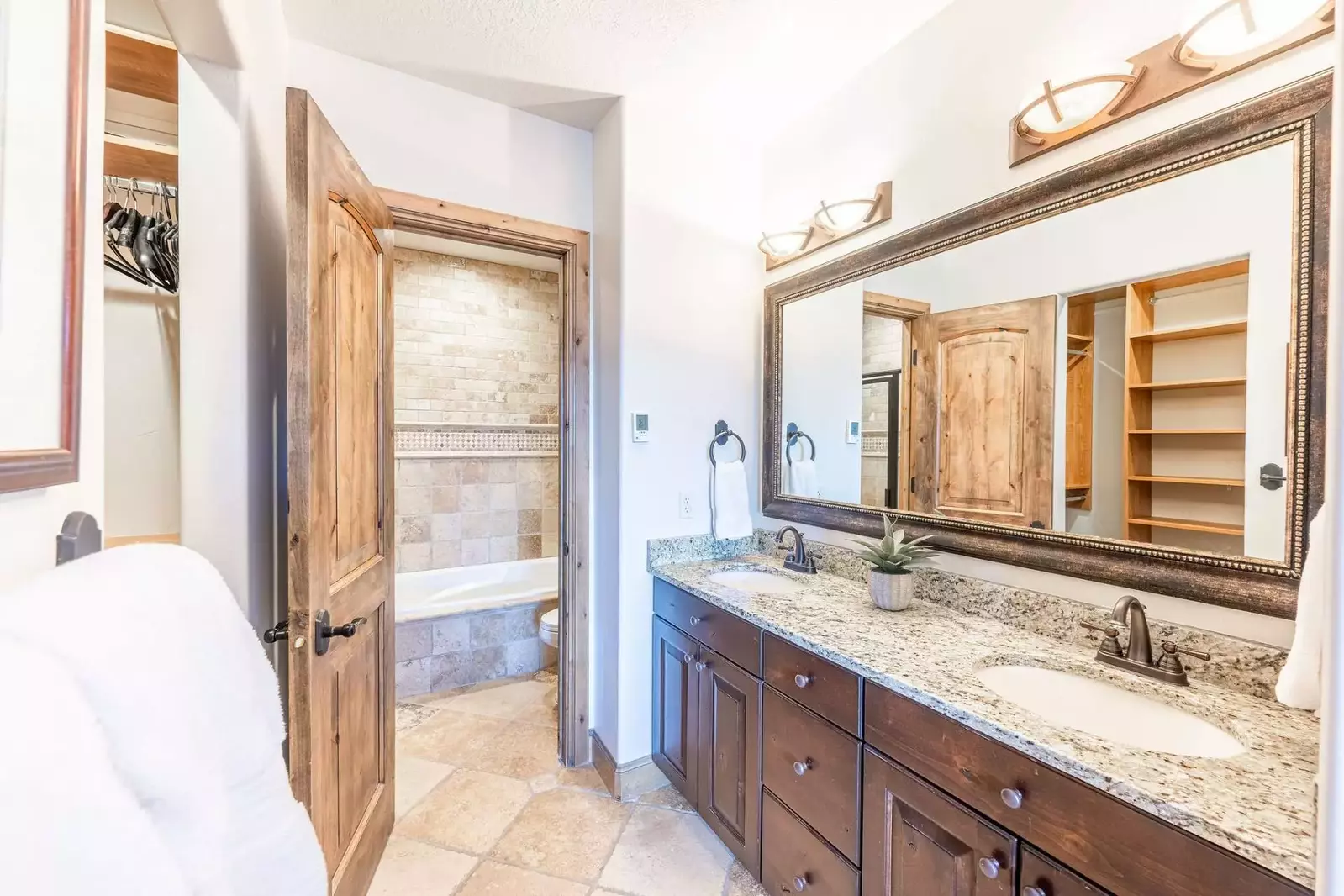 The main floor primary suite has a spacious en suite bathroom with a walk in glass rainfall shower, jetted tub and dual vanities. There is also a spac