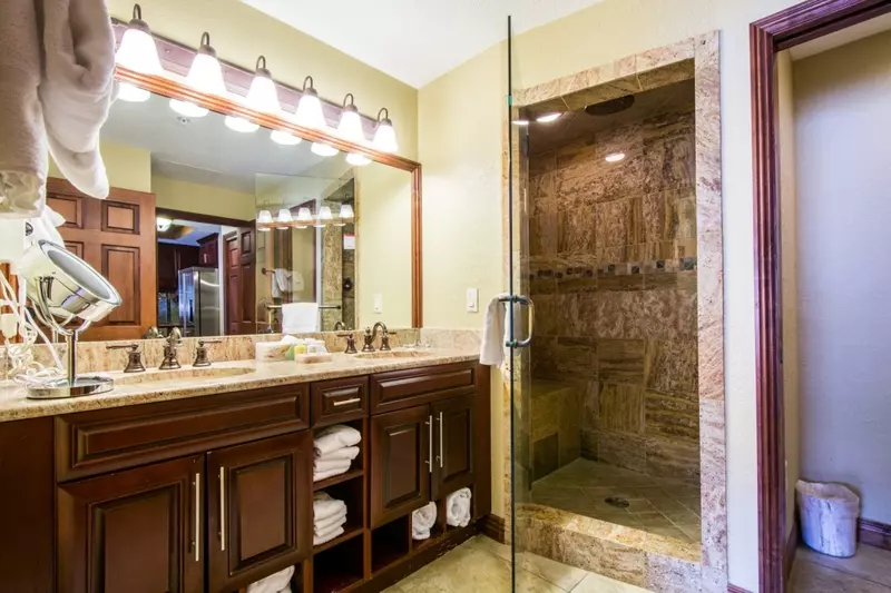 Master bathroom (1) with his and hers vanity, granite counters and a large steam/rainfall shower.