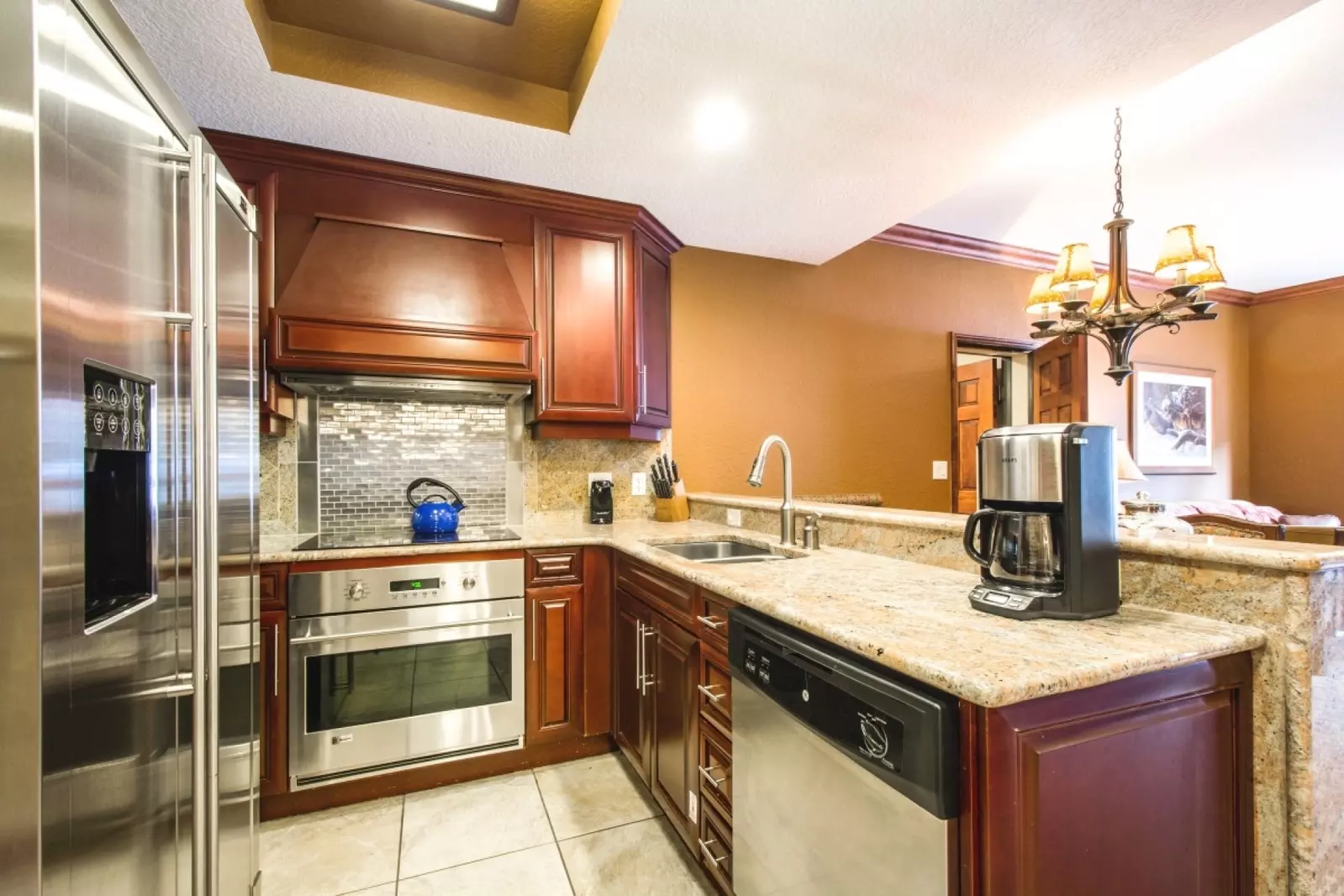Gourmet kitchen features granite counters, attractive cupboards & stainless steel appliances (french door fridge, microwave, dishwasher, stove).