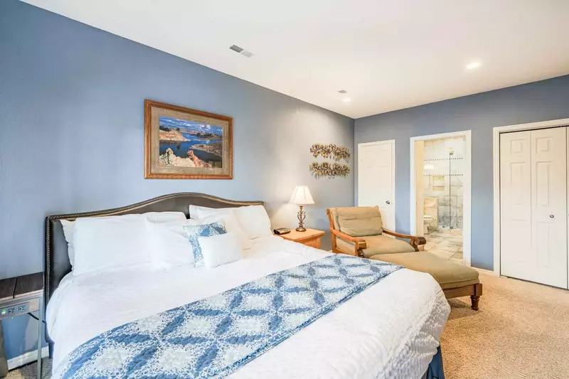 Primary (1) suite features a king size bed, flatscreen TV, large dresser, reading nook, with access to private balcony.