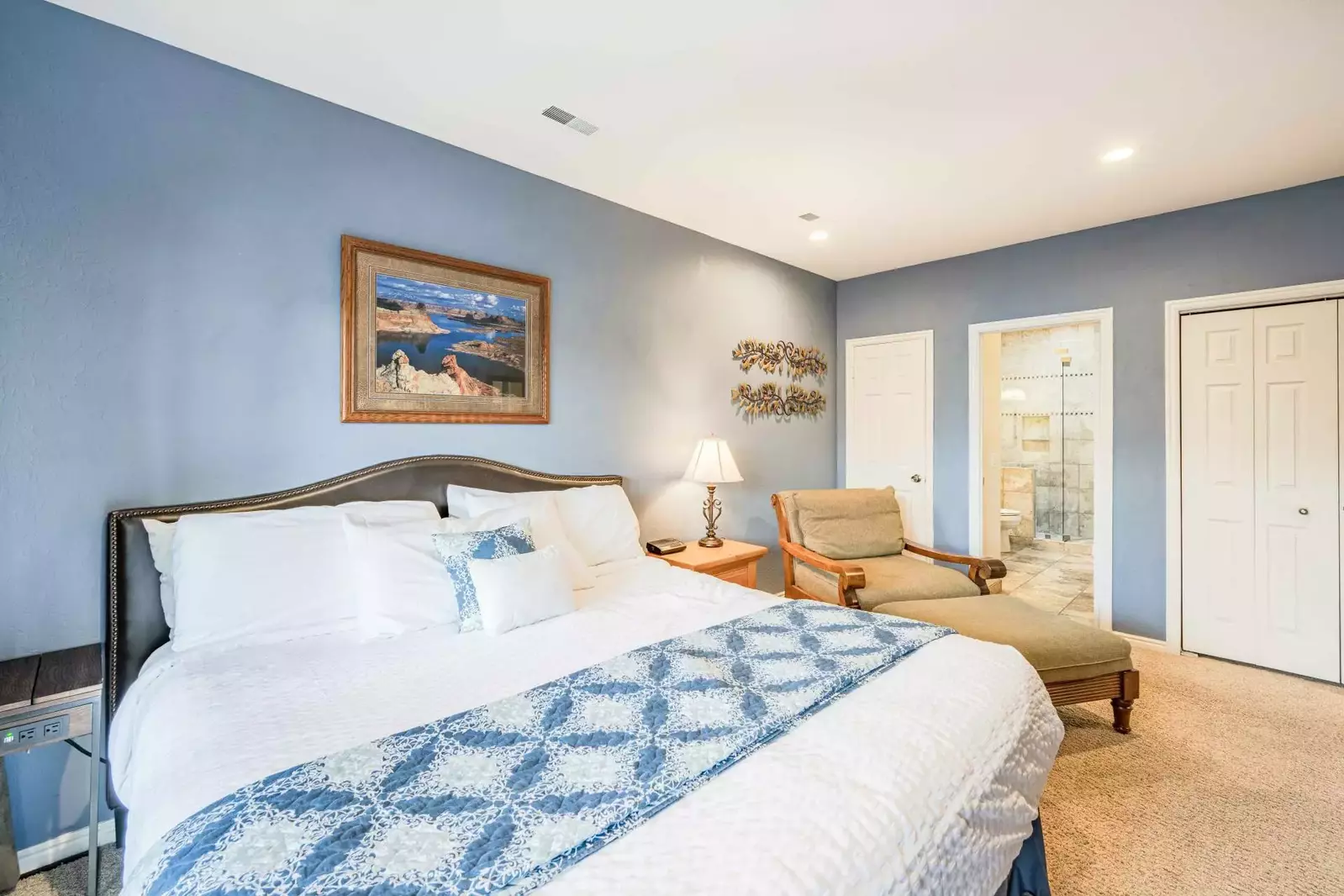 Primary (1) suite features a king size bed, flatscreen TV, large dresser, reading nook, with access to private balcony.