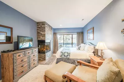 Comfortable Primary Suite Features a King Bed, Fireplace, HDTV & Private Balcony