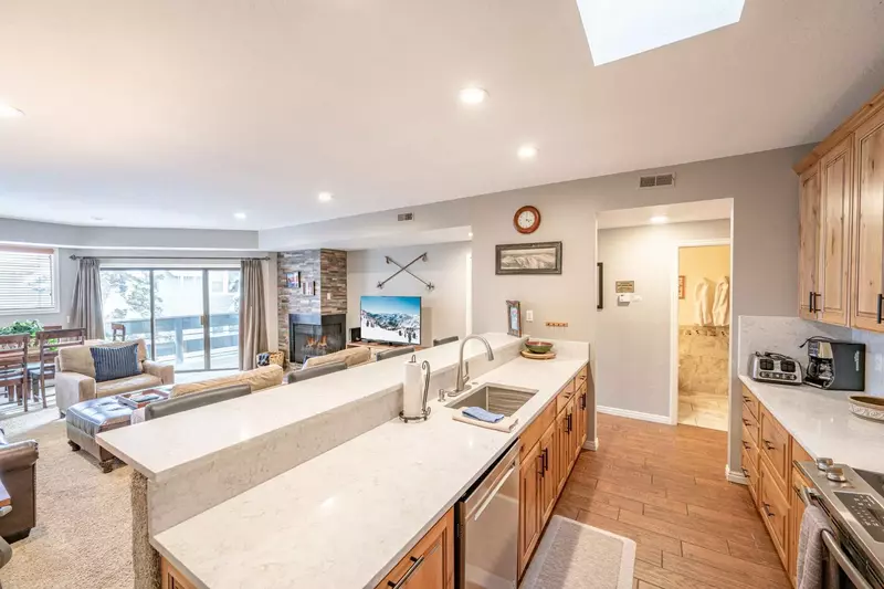 Full kitchen with additional seating for 3 at the breakfast bar  - Refrigerator, oven, stove, dishwasher, microwave, and coffee maker.