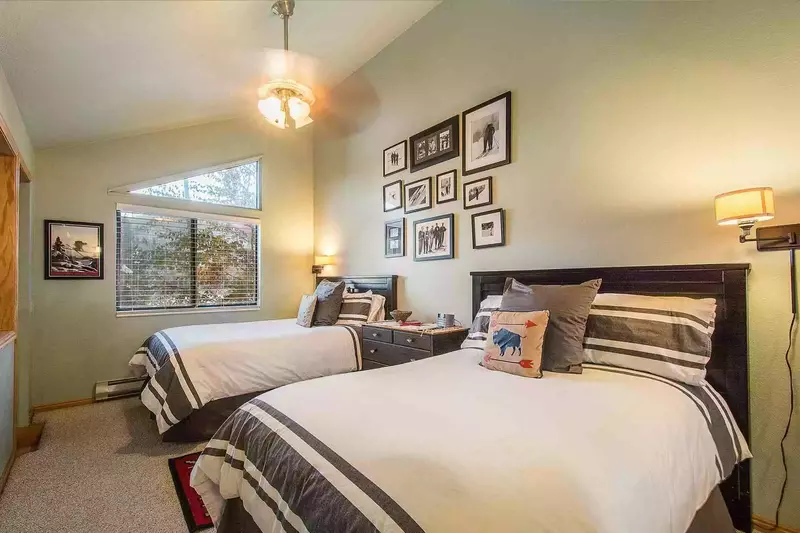 The bedroom offers two (2) full size double beds with high-end bedding & linens, large dresser, cathedral ceilings & closet.