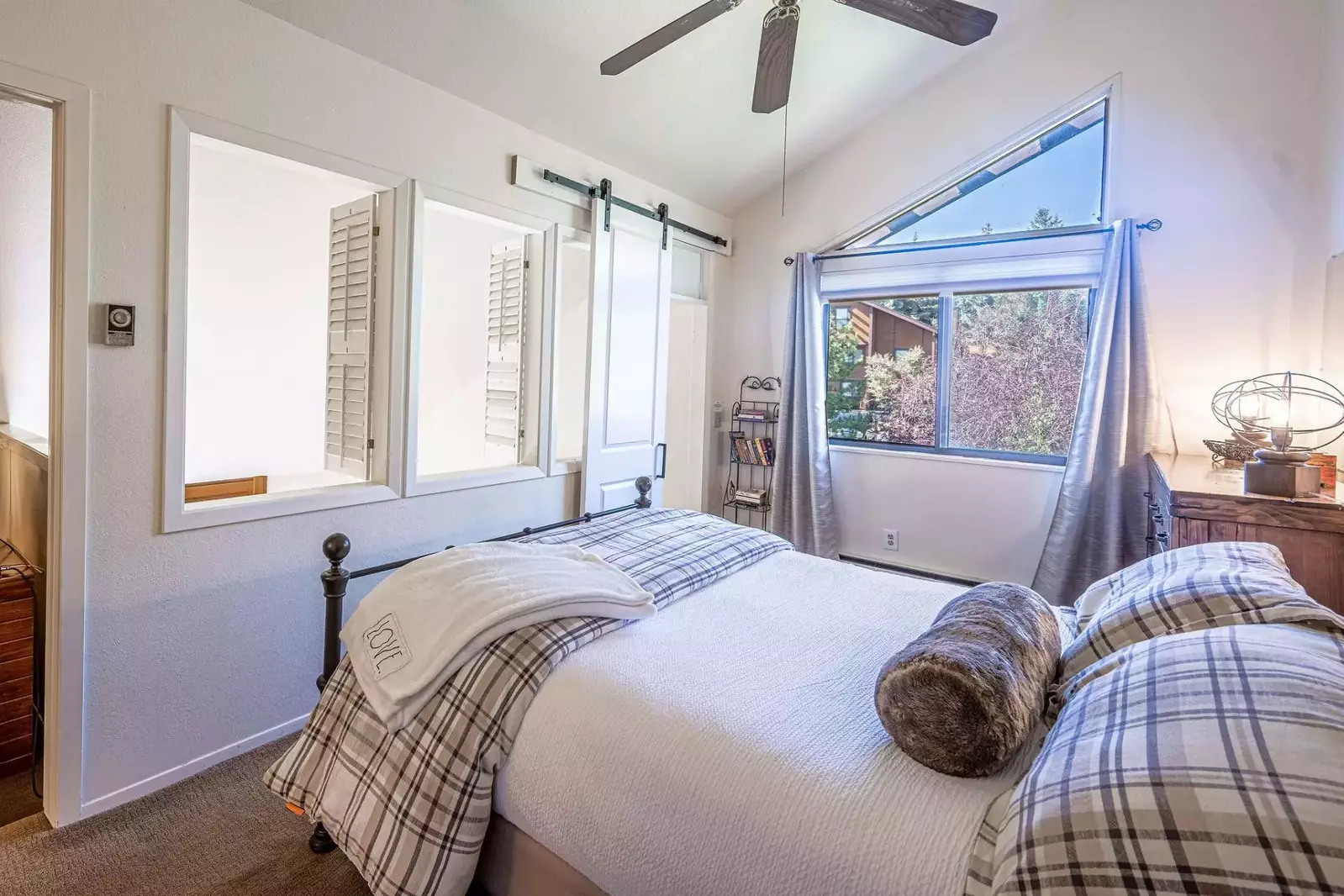 Spacious and Bright Guest Suite has a Queen Bed, Mountain Views, Large hardwood dresser for storage, ceiling fan, Barn Door, Loft shutters for privacy