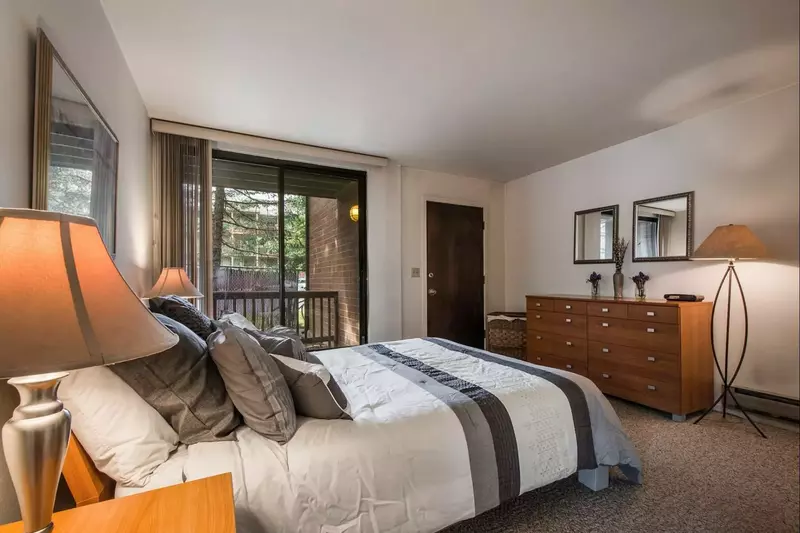The master bedroom features a queen-size bed with comfortable linens and bedding, a large closet and bedroom dresser for storage.