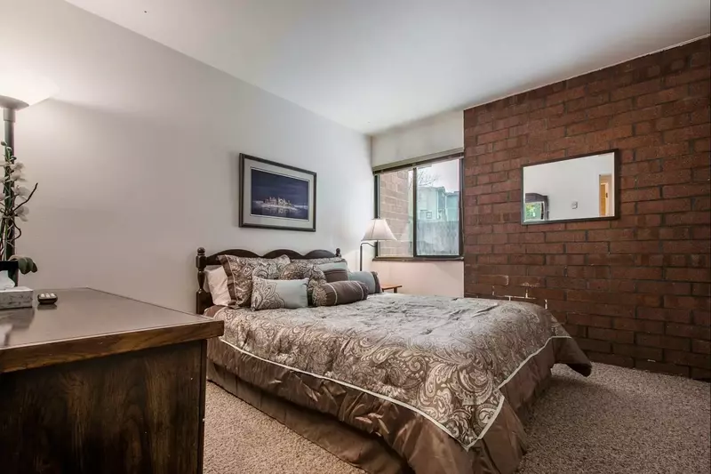The second bedroom features a queen-size bed with comfortable linens and bedding, closet and large dresser.