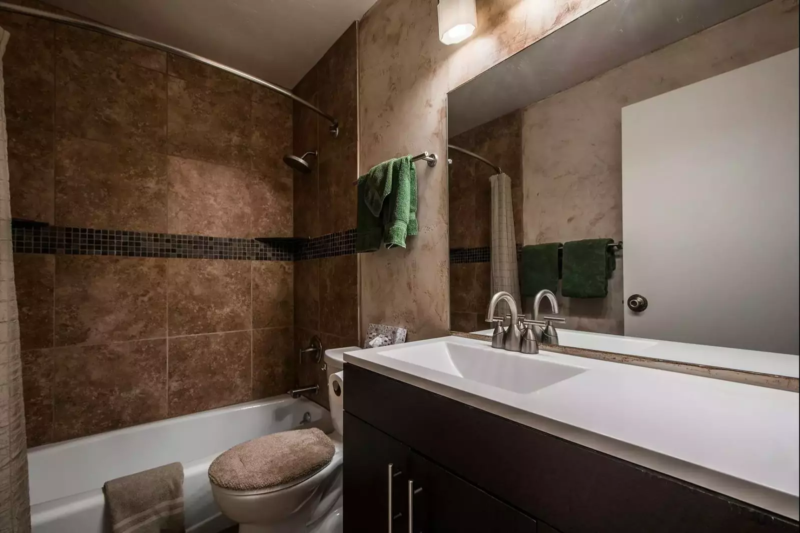 The second bathroom was recently renovated and features a bathtub and shower, extra long counter with hardwood cabinetry and lighting fixtures.